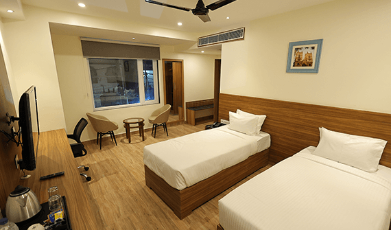 Deluxe room with comfortable seating at Sharda Residency